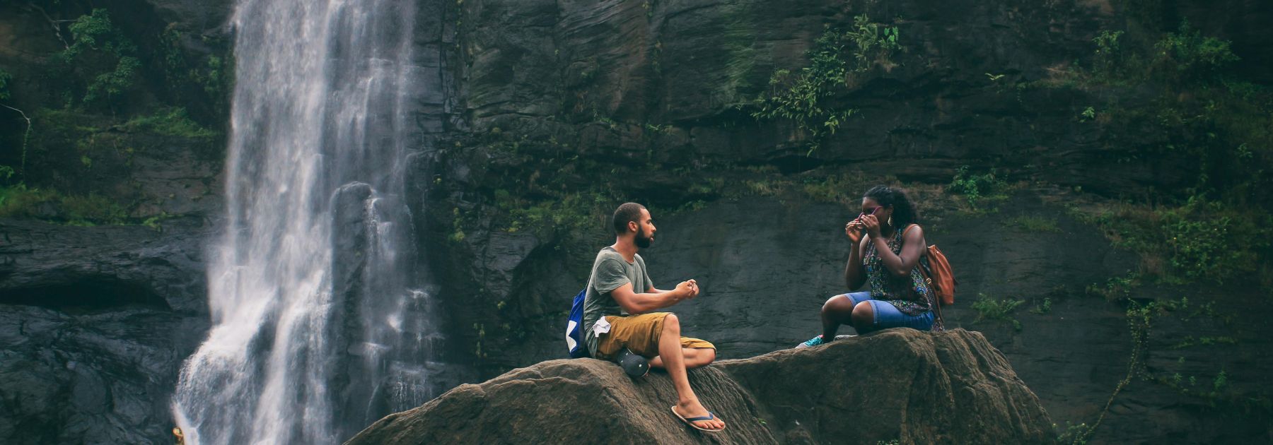 two people sat in front of a waterfall 